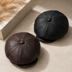 Vegan-friendly faux-leather baker boy hat laid flat to show its rounded gatsby-style shape